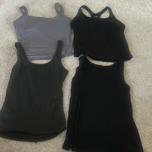 4 large tank tops. 2 with shell bra's, 2 plain tanks